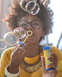 Woman blowing bubbles